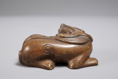 A Chinese bronze scroll or paper weight shaped as a Buddhist lion or Shishi, 18/19th C.