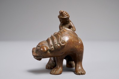 A Chinese bronze scroll or paper weight shaped as a mythical beast with rider, 19/20th C.