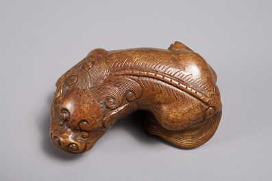 A Chinese bronze scroll or paper weight shaped as a Buddhist lion or Shishi, 18/19th C.