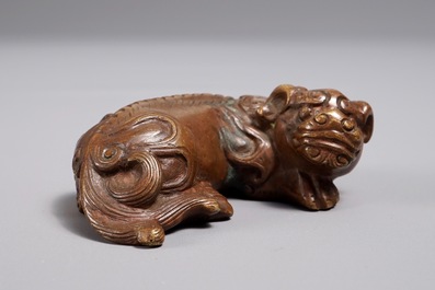A Chinese bronze scroll or paper weight shaped as a Buddhist lion or Shishi, 17/18th C.