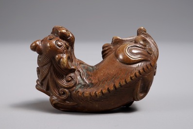 A Chinese bronze scroll or paper weight shaped as a Buddhist lion or Shishi, 17/18th C.