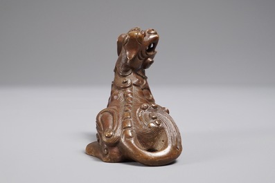 A Chinese bronze scroll or paper weight shaped as a Buddhist lion or Shishi, 18/19th C.