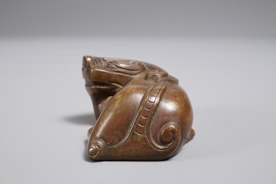 Een Chinees bronzen scroll- of papiergewicht in de vorm van een Boeddhistische leeuw of Shishi, 18/19e eeuw