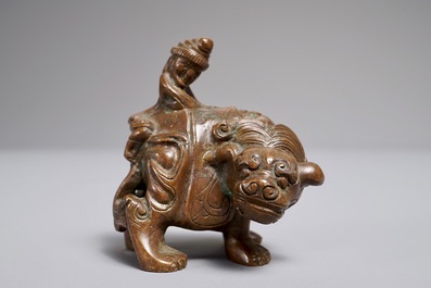 A Chinese bronze scroll or paper weight shaped as a mythical beast with rider, 19/20th C.