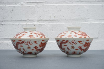 A pair of Chinese iron red dragon bowls and covers, Xianfeng mark, 19/20th C.