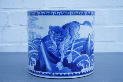 A Chinese blue and white cylindrical brush pot or bitong with mythical beasts, Kangxi