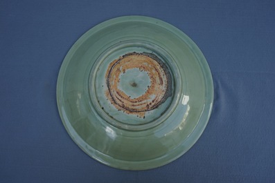 A Chinese Longquan celadon charger with underglaze floral design, Ming