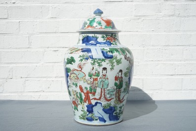 A Chinese wucai baluster vase and cover with figures in a landscape, Transitional period