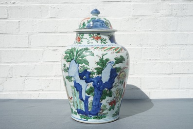 A Chinese wucai baluster vase and cover with figures in a landscape, Transitional period