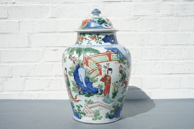 A Chinese wucai baluster vase and cover with figures in a landscape, Transitional period