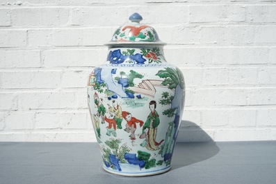A Chinese wucai baluster vase and cover with figures in a landscape, Transitional period