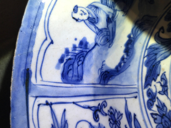 Un plat en porcelaine de Chine bleu et blanc &agrave; d&eacute;cor de figures dans un paysage, &eacute;poque Transition