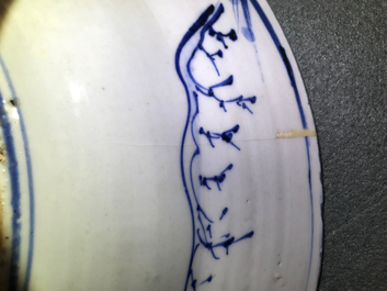 A Chinese blue and white dish with figures in a landscape, Transitional period