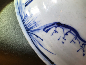 A Chinese blue and white dish with figures in a landscape, Transitional period