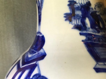 A pair of Chinese blue and white vases with ladies at a table, 19th C.