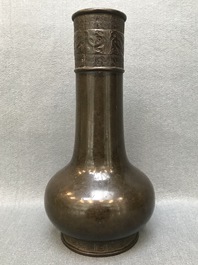 A Chinese bottle-shaped bronze vase with applied design, Yuan