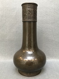 A Chinese bottle-shaped bronze vase with applied design, Yuan