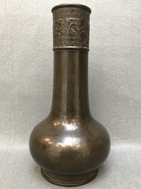 A Chinese bottle-shaped bronze vase with applied design, Yuan
