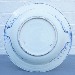 A Chinese blue and white dish with figures in a landscape, Transitional period