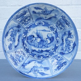 A Chinese blue and white dish with figures in a landscape, Transitional period