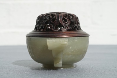 A Chinese celadon jade incense burner with wooden cover and stand, 18/19th C.