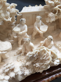 A Chinese carved ivory group of a village scene, 1st half 20th C.