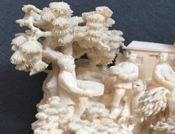 Un groupe en ivoire sculpt&eacute; d'une sc&egrave;ne de village, 1&egrave;re moiti&eacute; du 20&egrave;me