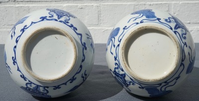 A pair of Chinese blue and white bottle vases with ribbons and precious objects, Kangxi