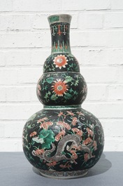 A Chinese black-ground famille verte double gourd dragon vase, 19th C.