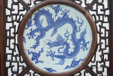 A Chinese carved wood table screen with a blue and white dragon medallion, Ming and 19th C.