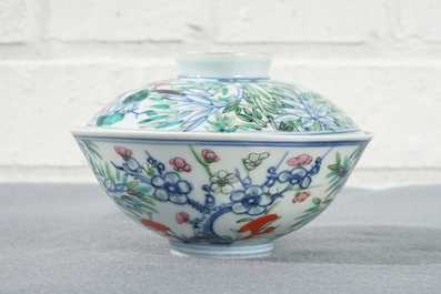 A Chinese famille rose bowl and cover with floral design, Qianlong mark, 19/20th C.