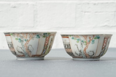 A pair of fine Chinese famille rose cups and saucers with figures in a garden, Yongzheng/Qianlong