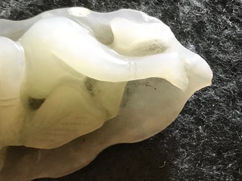 A Chinese celadon jade model of a reclining lady on lotus leaf, Qing