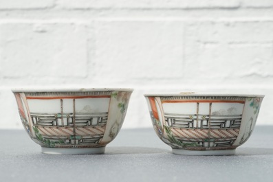 A pair of fine Chinese famille rose cups and saucers with figures in a garden, Yongzheng/Qianlong