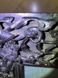 A Chinese carved wood frame depicting mythical beasts, 19th C.