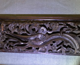 A Chinese carved wood frame depicting mythical beasts, 19th C.