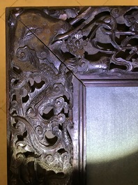 A Chinese carved wood frame depicting mythical beasts, 19th C.