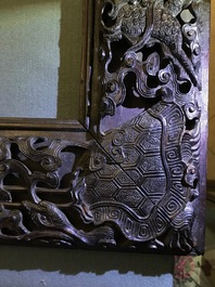 A Chinese carved wood frame depicting mythical beasts, 19th C.