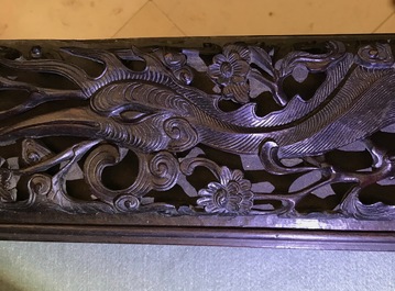 A Chinese carved wood frame depicting mythical beasts, 19th C.