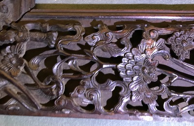 A Chinese carved wood frame depicting mythical beasts, 19th C.