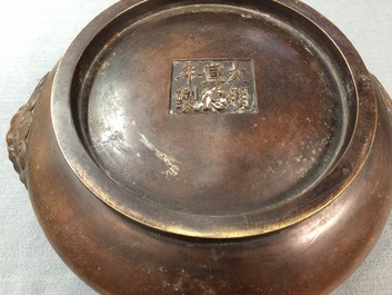 A Chinese bronze censer with lion heads, Xuande mark, 19/20th C
