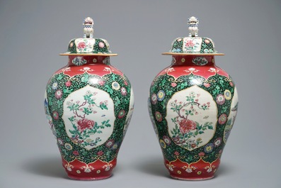A pair of Chinese famille rose black-ground vases and covers, Yongzheng