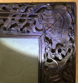 A Chinese carved wood frame depicting mythical beasts, 19th C.