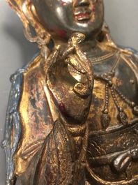 A Chinese lacquered and gilt bronze figure of Guanyin, Ming