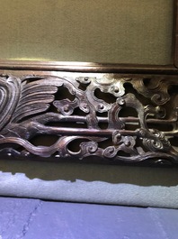 A Chinese carved wood frame depicting mythical beasts, 19th C.