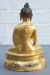 A Tibetan gilt bronze figure of Buddha with vajra, 19th C.