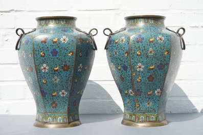 A pair of Chinese cloisonn&eacute; vases with floral design and ring handles, 19th C.