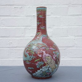 A Chinese oxblood-glazed bottle vase with overglaze design of a dragon and a carp, 19th C.