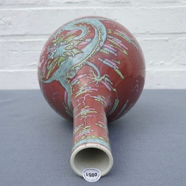 A Chinese oxblood-glazed bottle vase with overglaze design of a dragon and a carp, 19th C.