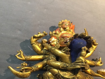 A Sino-Tibetan gilt bronze figure of Mahakala and his consort Yab-Yum, 19/20th C.